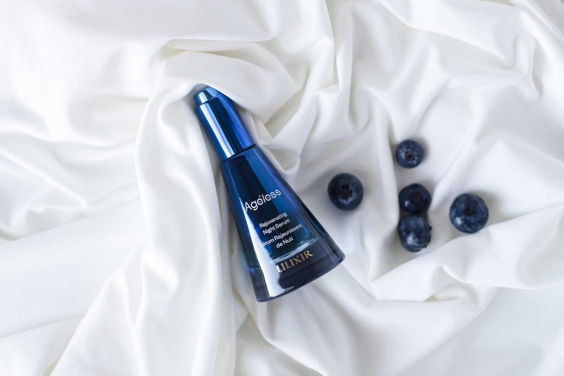 LILIXIR Ageless Rejuvenating Night Serum, a blue serum bottle with blueberries on a white fabric background