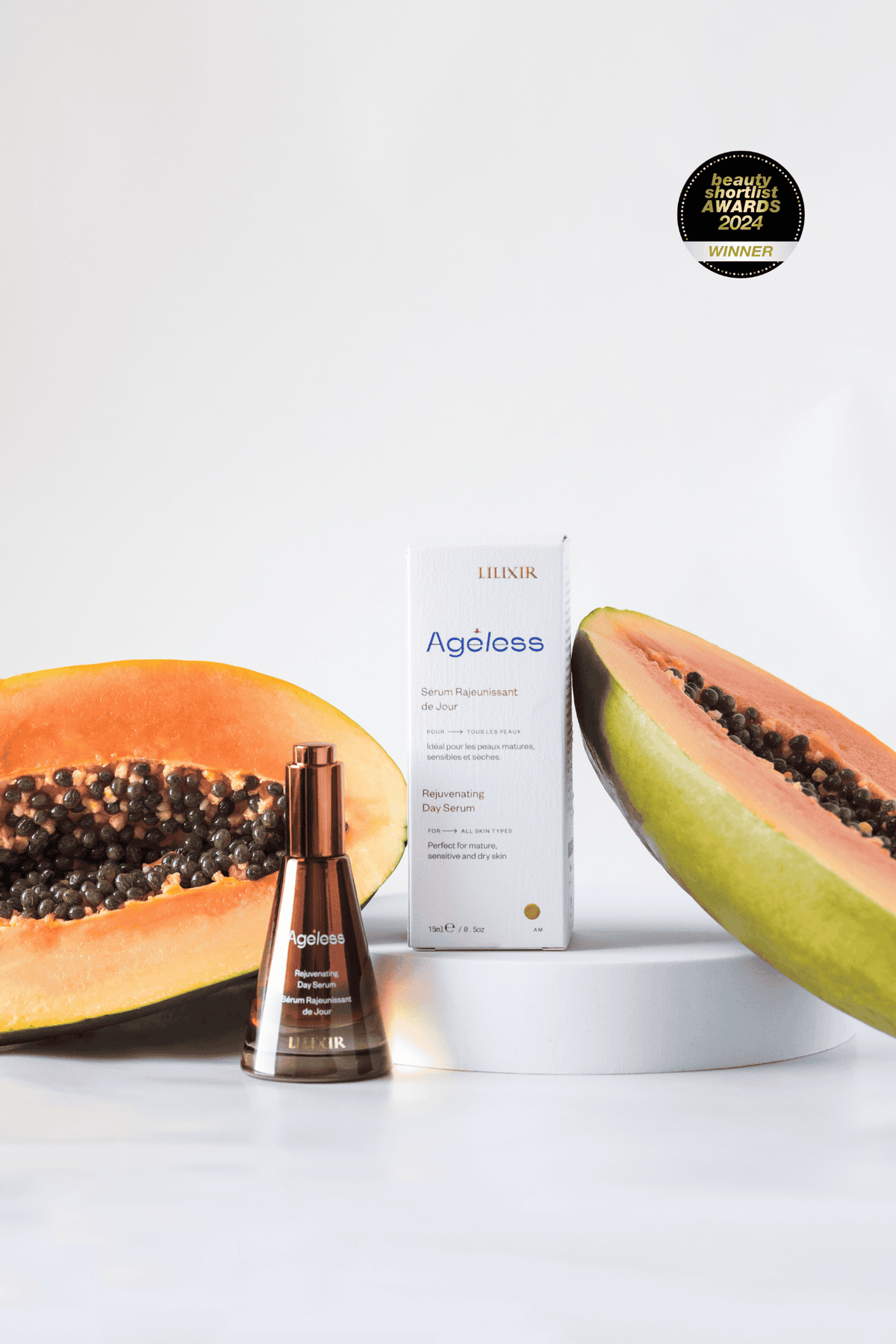 LILIXIR Ageless rejuvenating day serum, skincare product with a halved papaya on a white background