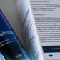 Close-up of a skincare product bottle labeled Flawless with a white product information card showing ingredients and emulsifiers, photographed on a clean white background.