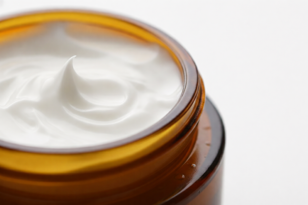 Close-up of a jar of white cream with a white background