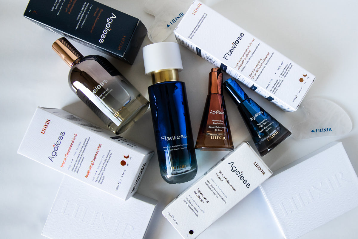 A flat-lay arrangement of skincare products from LILIXIR on a white background, including a dark blue bottle, a brown bottle, white boxes, and a blue box.