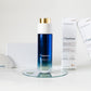 LILIXIR Flawless skincare set featuring a blue gradient bottle with a gold cap, two white product boxes, and a white crystal gua Sha arranged on a white surface with a glass coaster.