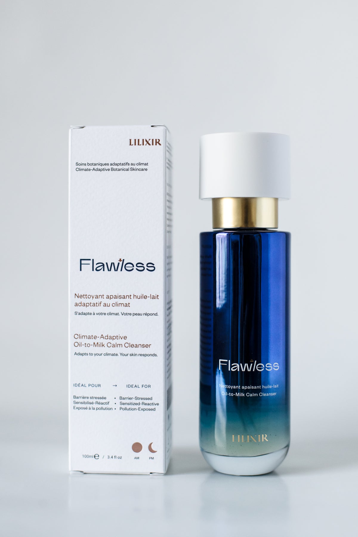 A bottle of LILIXIR Flawless Climate-Adaptive Oil-to-Milk Cleanser next to its white packaging box, set against a clean light gray background.