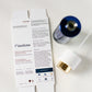 LINIK Flawless face cleanser set shown with its white outer carton packaging and a blue-and-gold serum bottle on a clean white background.