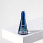 Blue bottle with LILIXIR Ageless branding on a white surface and background