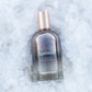 Bottle of 'Ageless' awakening essence on an ice textured white background