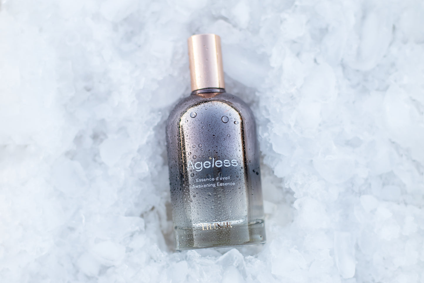 Bottle of 'Ageless' awakening essence on an ice textured white background