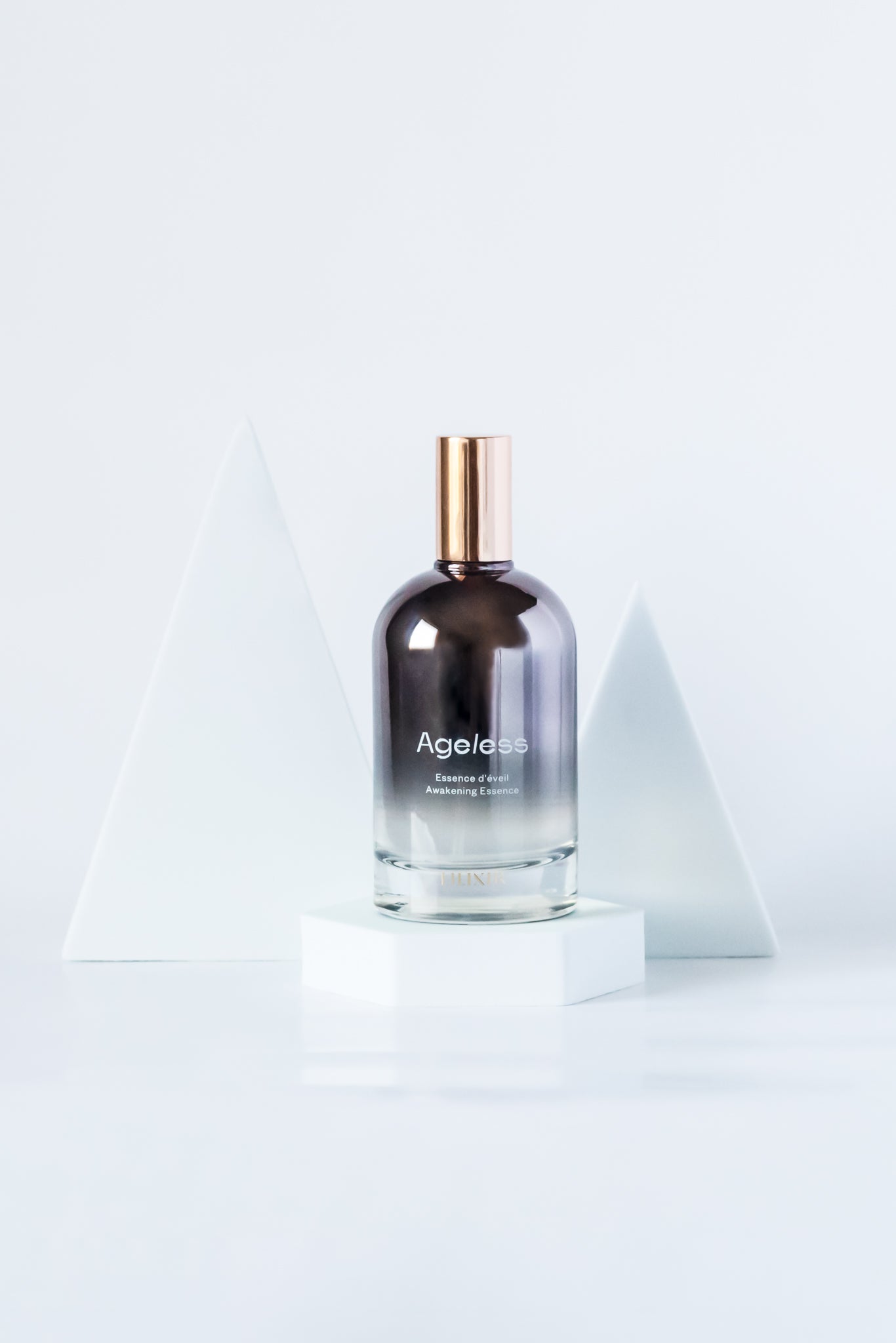 LILIXIR Ageless Awakening Essence glass bottle with golden cap on a white background