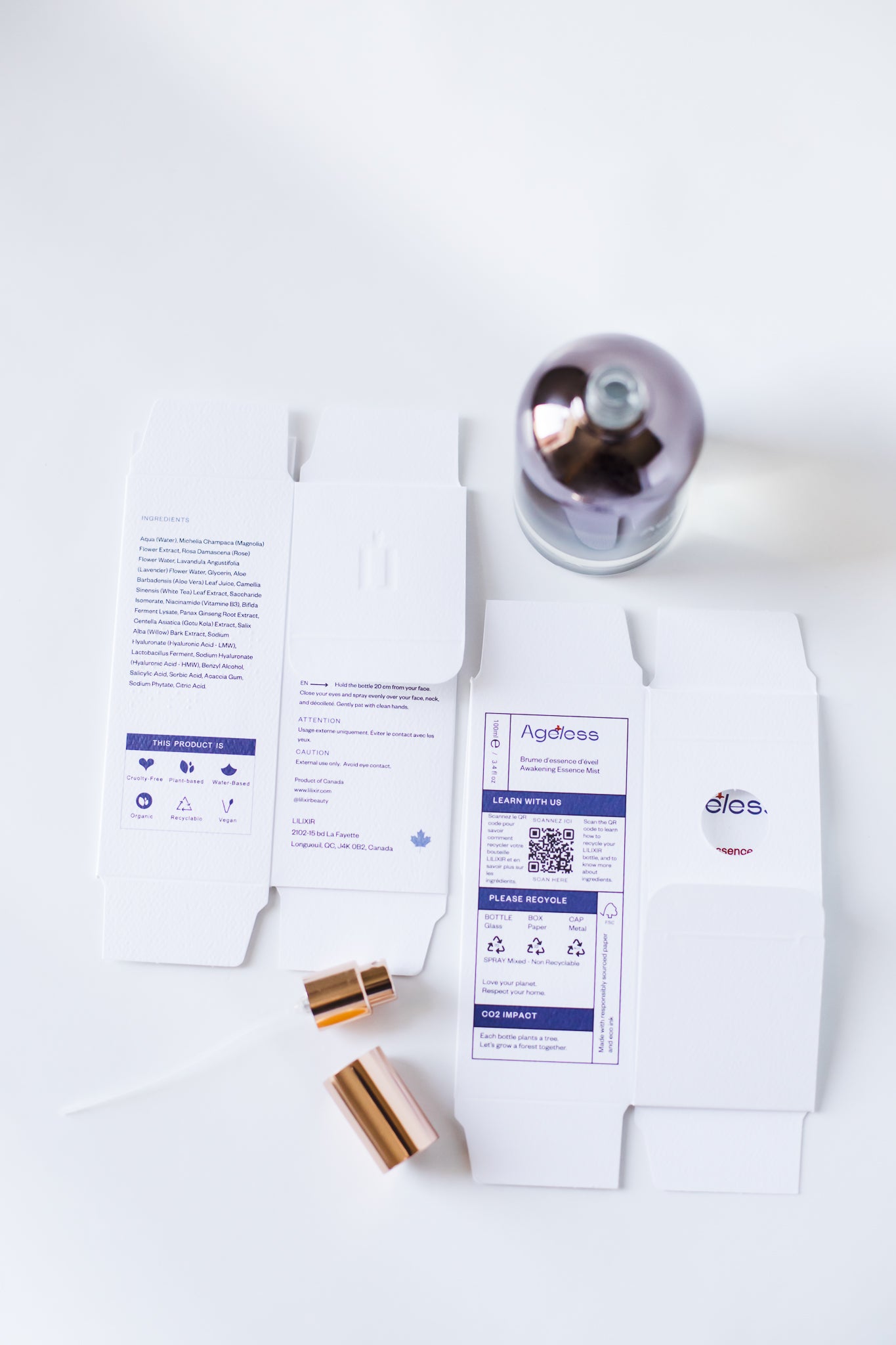 Product packaging with a label on a white background. White LILIXIR Ageless Awakening Essence bottle and flat packaging with labels and gold cap and spray on a white background