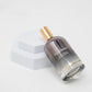 Lilixir climate essence awakening  bottle with gold cap on a white background