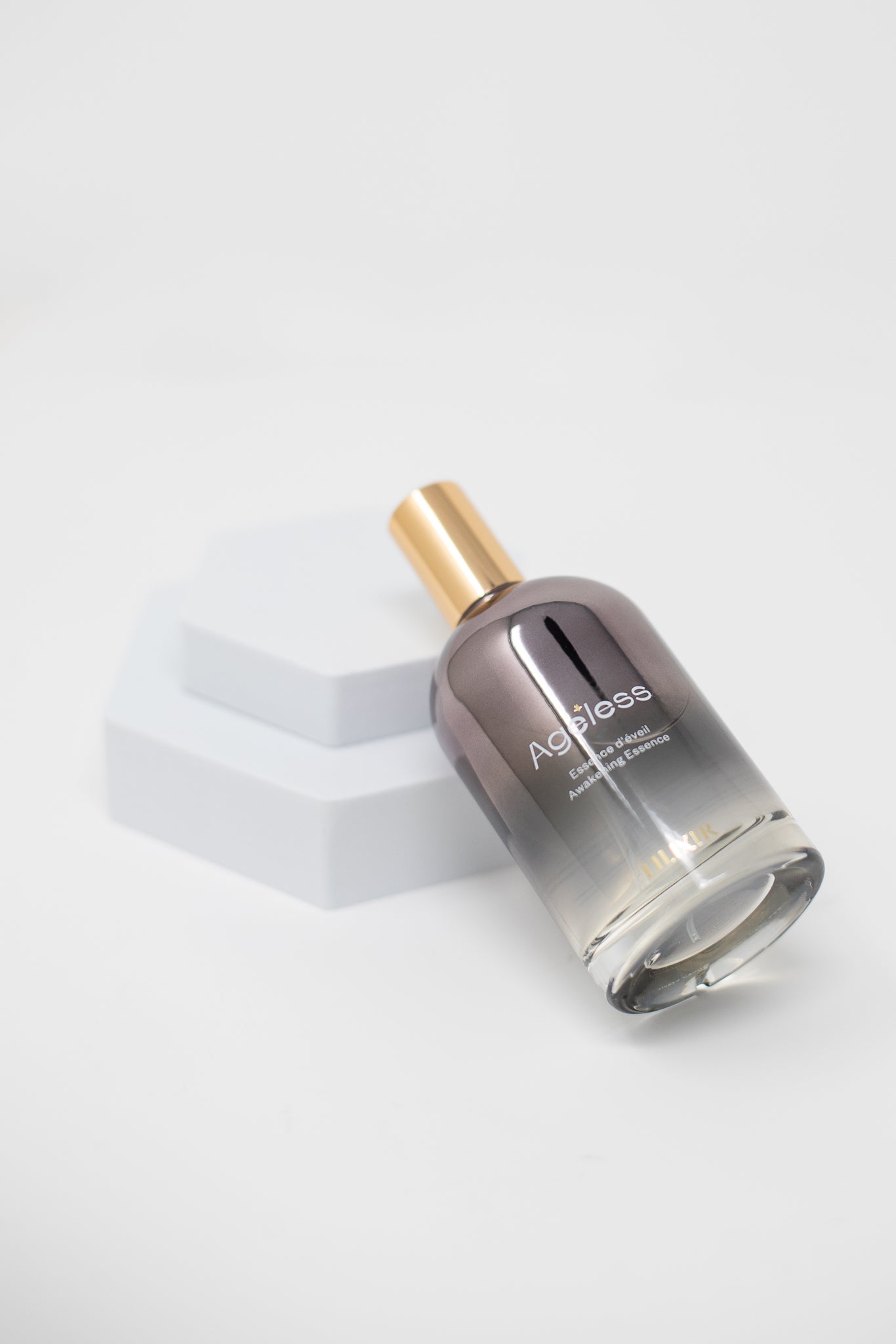 Lilixir climate essence awakening  bottle with gold cap on a white background