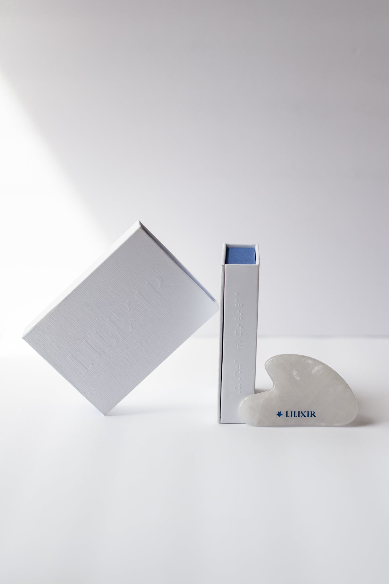 White heart-shaped object with 'LILIXIR' branding on a white background